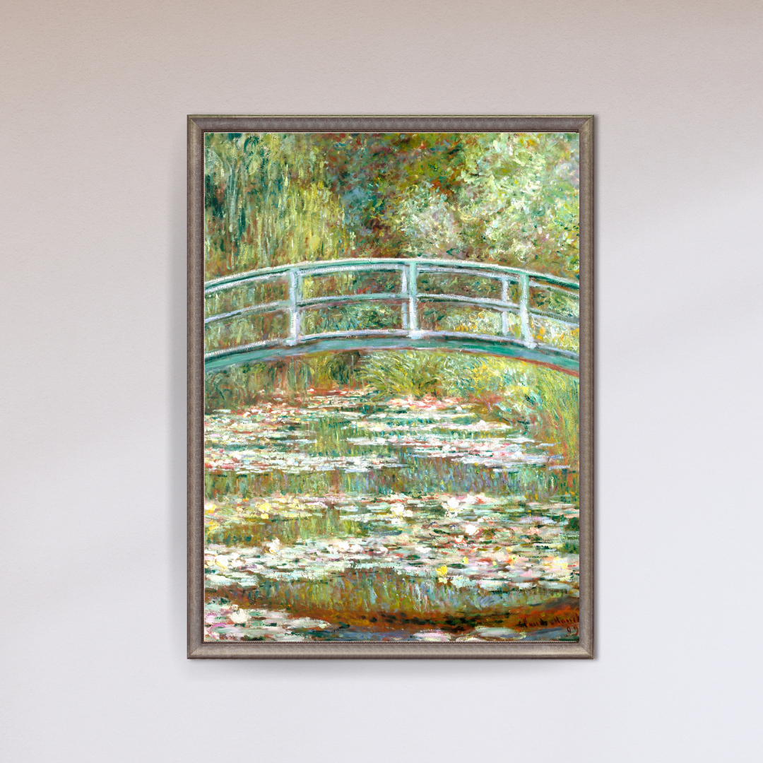 Framed painting of a bridge over water lilies on a white wall